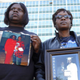 Members of the group Silence Is Violence hold photos of relatives killed in New Orleans. (Associated Press)